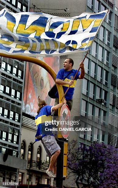 Fans of the Argentine soccer team Boca Juniors celebrate 28 November 2000 in central Buenos Aires the team's victory in the final of the...