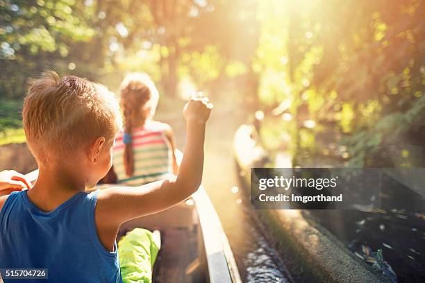 kids enjoying ride in a boat through the forest river - kids at river stock pictures, royalty-free photos & images