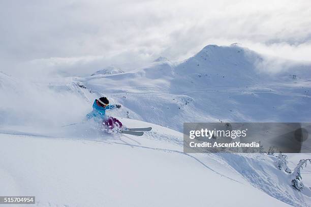 female skier making a powder turn - whistler village stock pictures, royalty-free photos & images