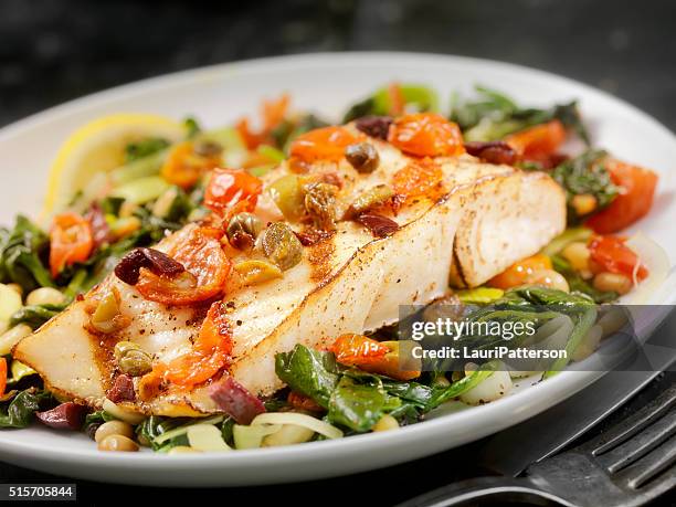 grilled halibut with capers,olives and tomatoes - fish dinner stock pictures, royalty-free photos & images