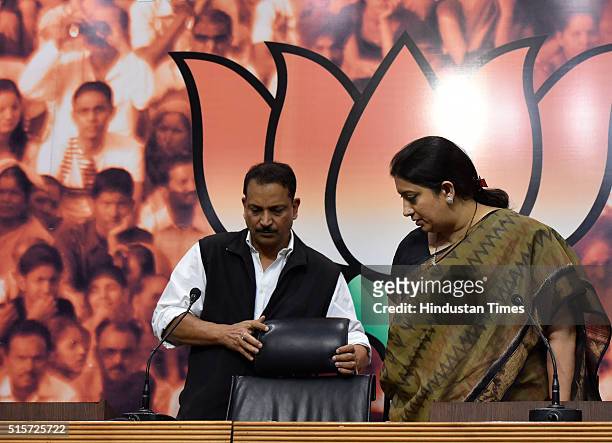 Minister Smriti Irani and BJP senior leader Rajiv Pratap Rudy during the press conference at BJP Headquarters on March 15, 2016 in New Delhi, India....