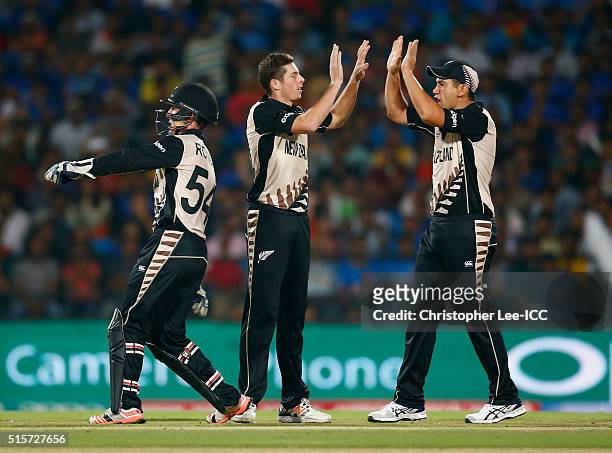 Mitchell Santner of New Zealand celebrates taking the wicket of Rohi Sharma of India with Ross Taylor of New Zealand during the ICC World Twenty20...