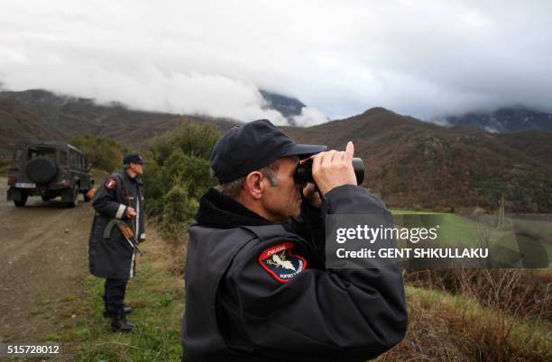 Albanian police officers patrol at the Albanian-Greek border in Carshove near the city of Permet on March 15, 2016. EU interior ministers were set to...