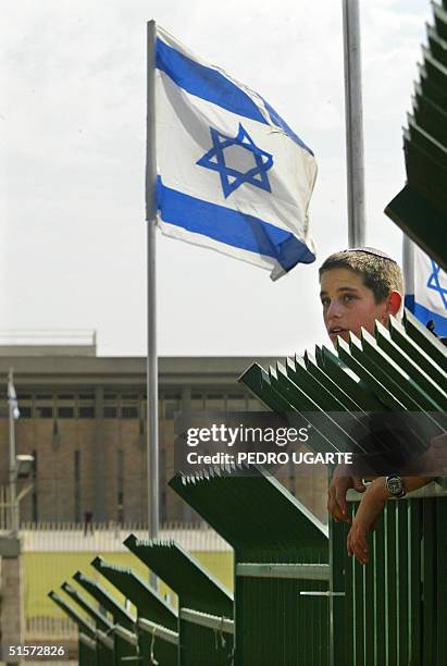 Jewish settler takes part in a demonstration in front of the Knesset moments before the start of the second day of debate on Israeli Prime Minister...