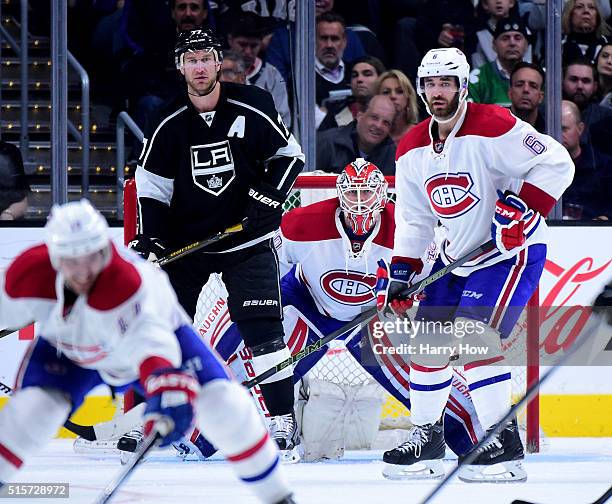 Ben Scrivens of the Montreal Canadiens looks for the puck between Jeff Carter of the Los Angeles Kings and Greg Pateryn at Staples Center on March 3,...