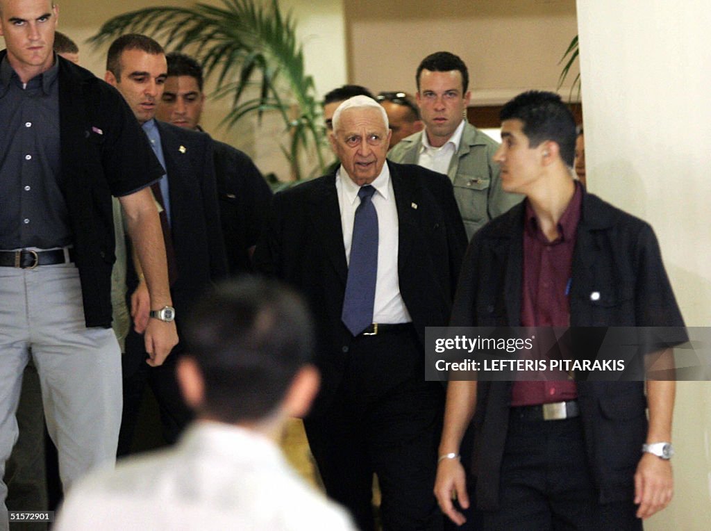 Surrounded by aides and bodyguards, Israeli Prime Minister Ariel ...