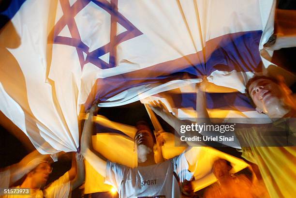 Israeli settlers demonstrate against Israeli Prime Minister Ariel Sharon's Gaza Strip disengagement plan outside the Knesset October 26, 2004 in...