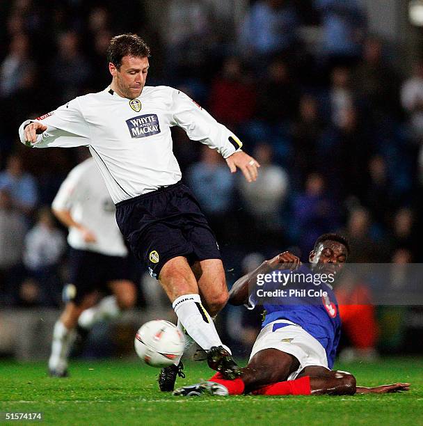 Valery Mezague of Portsmouth tackles Sean Gregan of Leeds during the Carling Cup Third round match between Portsmouth and Leeds United at Fratton...