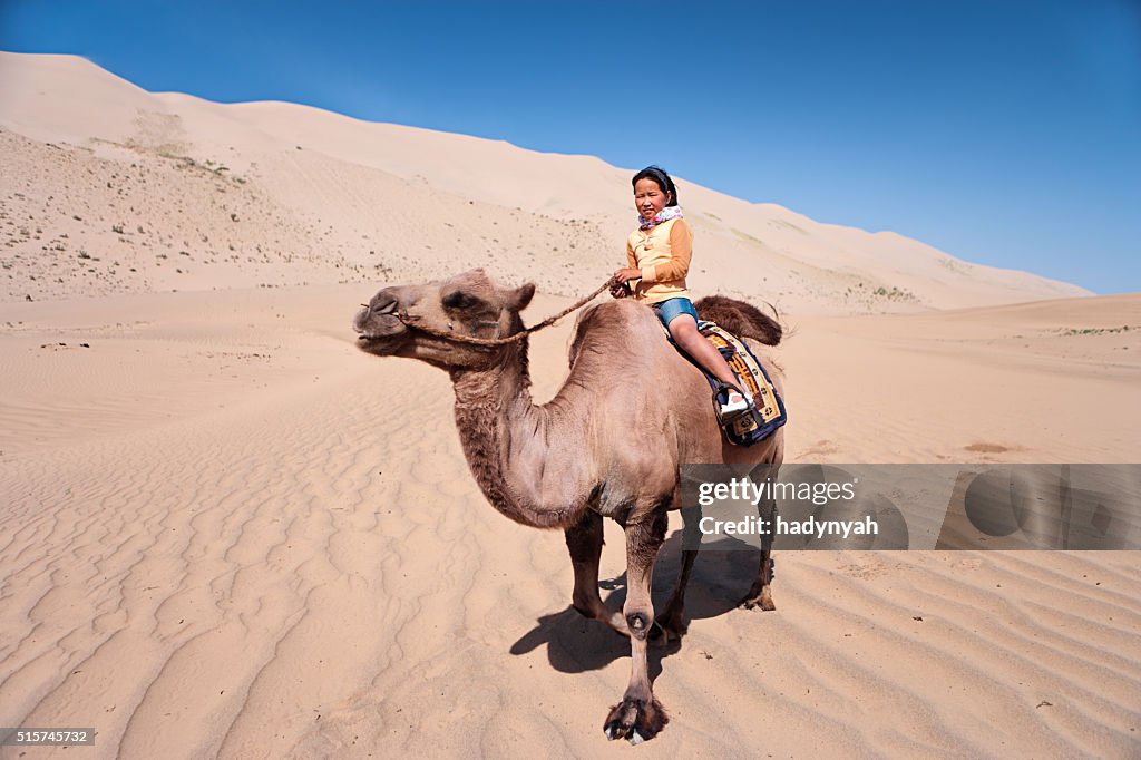 Mongolian girl riding on the camel, Gobi Desert