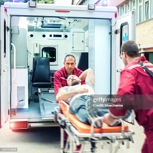 rescue team providing first aid - red cross stock pictures, royalty-free photos & images