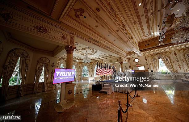 Members of the Trump campaign staff prepare the stage for a press conference at the Mar-A-Lago Club's Donald A. Trump Ballroom March 15, 2016 in Palm...