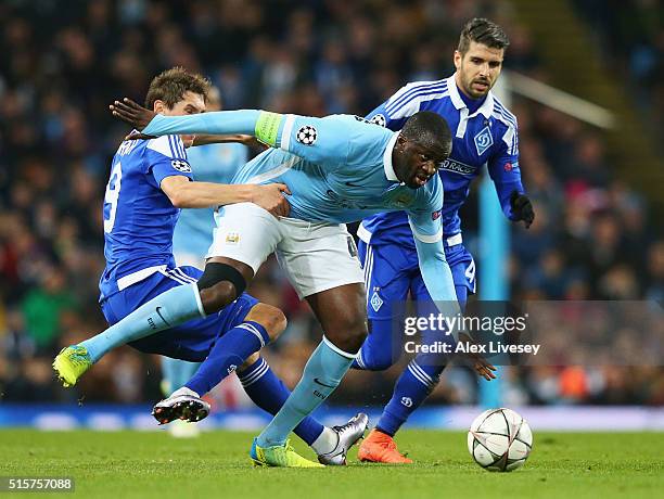 Yaya Toure of Manchester City beats Denys Garmash and Miguel Veloso of Dynamo Kiev during the UEFA Champions League round of 16 second leg match...