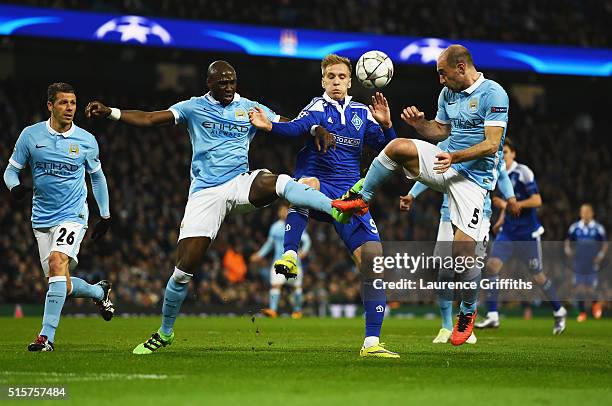 Eliaquim Mangala and Pablo Zabaleta of Manchester City challenge Mykola Morozyuk of Dynamo Kiev during the UEFA Champions League round of 16 second...