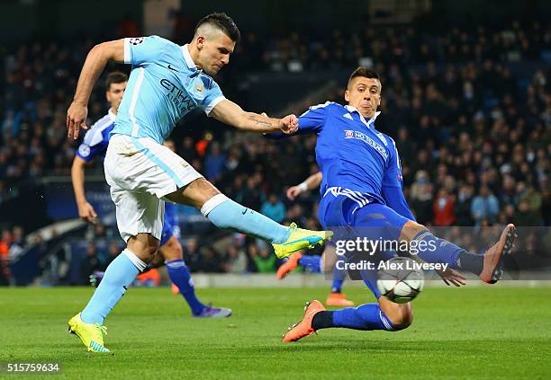 Sergio Aguero of Manchester City shoots past Yevhen Khacheridi of Dynamo Kiev during the UEFA Champions League round of 16 second leg match between...