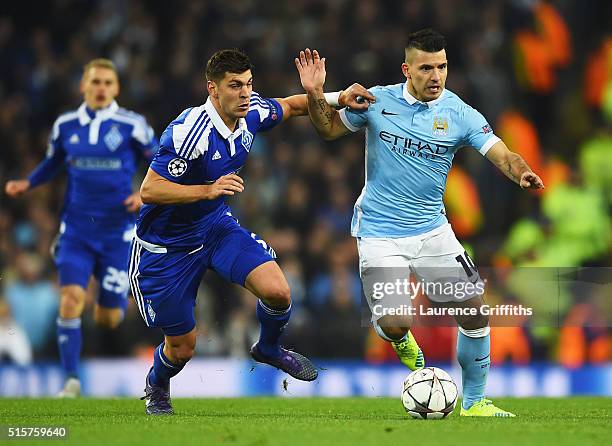 Sergio Aguero of Manchester City holds off Aleksandar Dragovic of Dynamo Kiev during the UEFA Champions League round of 16 second leg match between...