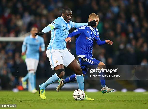 Yaya Toure of Manchester City holds off Vitaliy Buyalskiy of Dynamo Kiev during the UEFA Champions League round of 16 second leg match between...