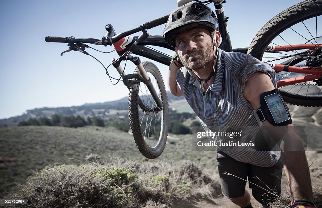 Man Carries Bike up Extreme Terrain, Tech Gear