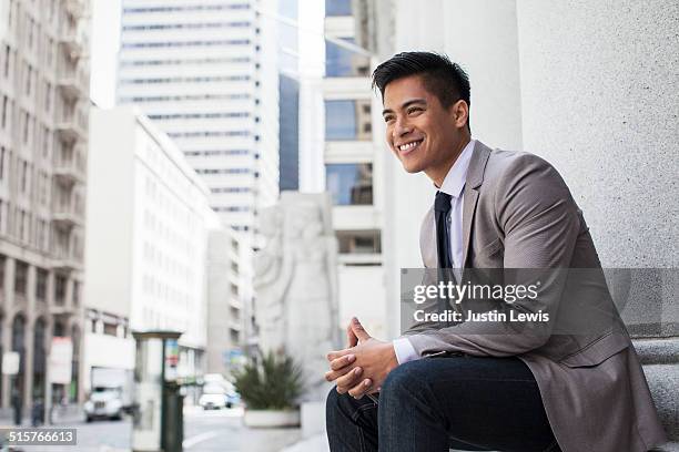 young asian businessman in city smiling - asian businessman happy foto e immagini stock