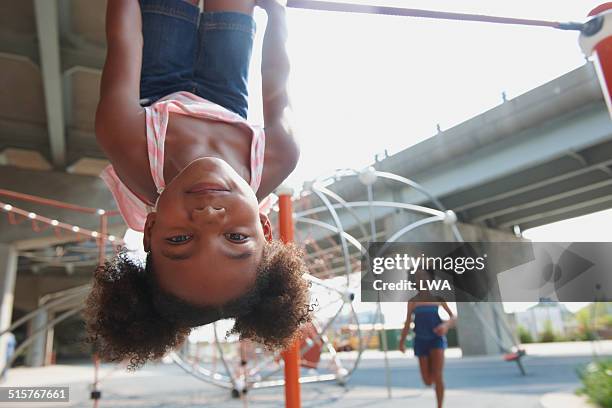 young girl hanging upside down - upside down bildbanksfoton och bilder