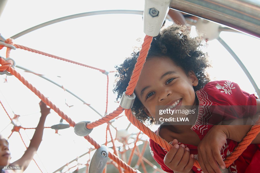 Young girl smiling on climbing gym