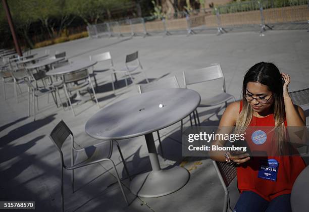 Volunteer waits to speak with attendees outside a campaign event for Senator Bernie Sanders, an independent from Vermont and 2016 Democratic...