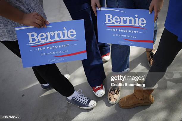 Volunteers display campaign signs for a photograph outside a campaign event for Senator Bernie Sanders, an independent from Vermont and 2016...