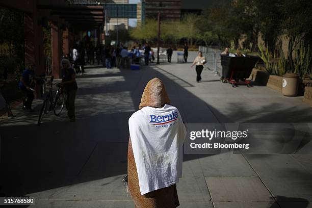 Volunteer waits to speak with attendees outside a campaign event for Senator Bernie Sanders, an independent from Vermont and 2016 Democratic...