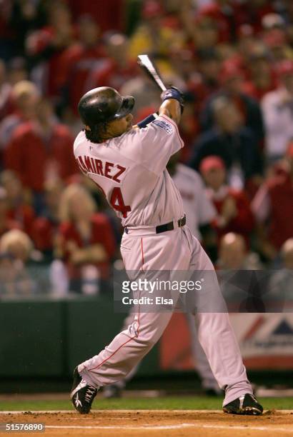 Manny Ramirez of the Boston Red Sox hits a solo home run in the first inning against the St. Louis Cardinals during game three of the World Series on...
