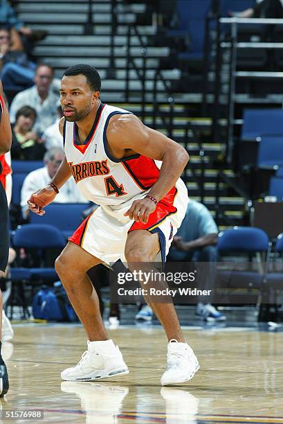 Derek Fisher of the Golden State Warriors plays defense against the Portland Trail Blazers during the preseason game at the Arena in Oakland on...