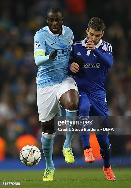 Yaya Toure of Manchester City challenges for the ball with Miguel Veloso of FC Dynamo Kyiv during the UEFA Champions League Round of 16 second leg...