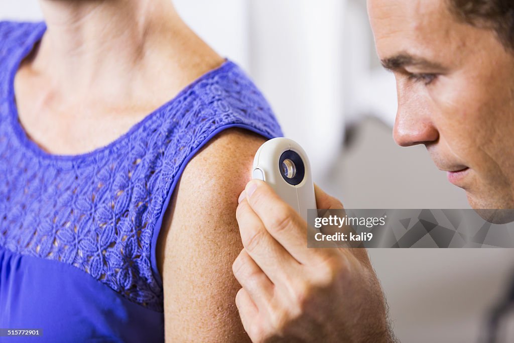 Dermatologist examining patient looking for skin cancer