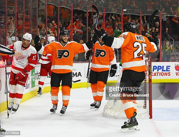 Shayne Gostisbehere of the Philadelphia Flyers celebrates his goal at 18:54 of the third period against Petr Mrazek of the Detroit Red Wings and is...