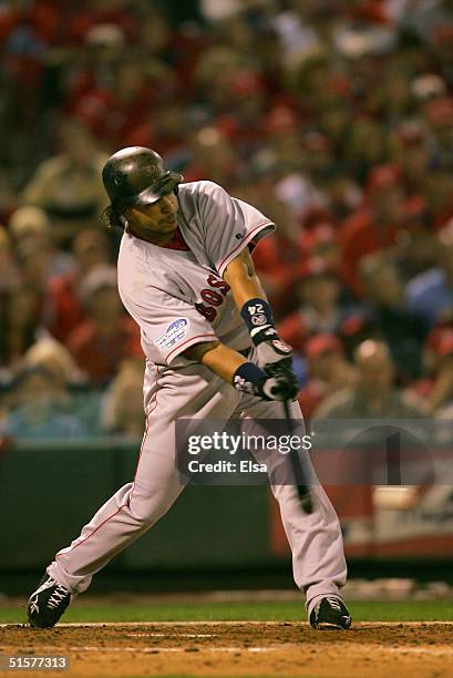 Manny Ramirez of the Boston Red Sox hits a RBI single in the fifth inning against the St. Louis Cardinals during game three of the World Series on...