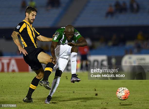 Colombia's Atletico Nacional's player Victor Ibarbo vies for the ball with Uruguayan Penarol Tomas Costa during their Libertadores Cup football match...