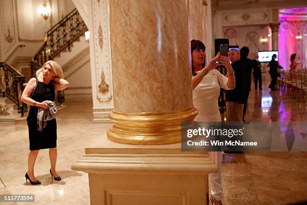 Guests arrive and take photographs of the media during a primary night event at Republican presidential candidate Donald Trump;s Donald J. Trump...