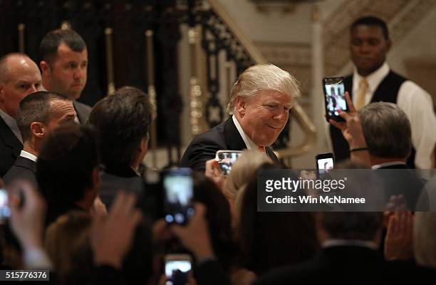 Republican presidential candidate Donald Trump arrives for a primary night press conference at the Mar-A-Lago Club's Donald J. Trump Ballroom March...