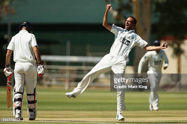 Trent Copeland of the Blues celebrates taking the wicket of Rob Quiney of the Bushrangers during day two of the Sheffield Shield match between...