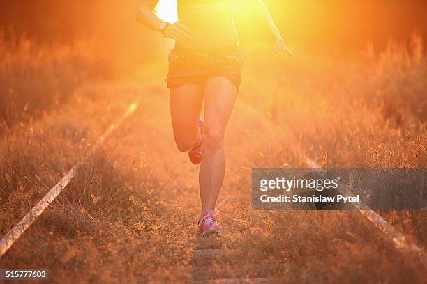 girl jogging in forest - railway tracks sunset stock pictures, royalty-free photos & images