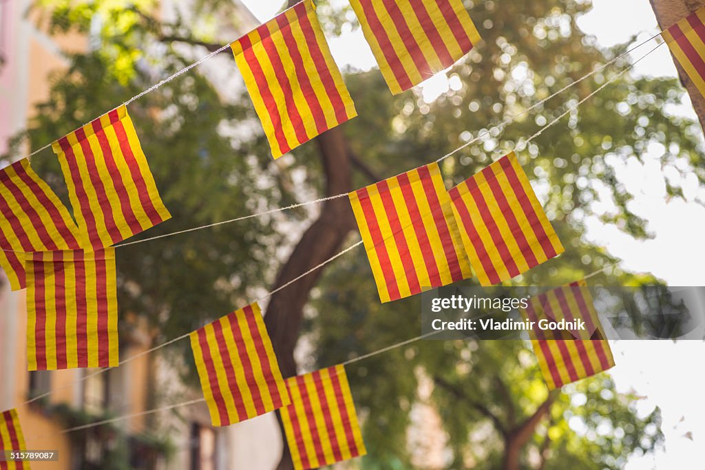 Low angle view of striped flags against tree