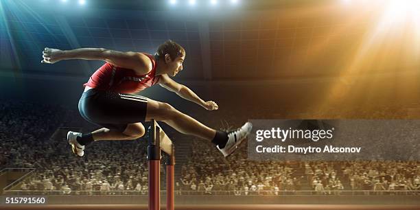 male athlete hurdling on sports race - hordelopen atletiekonderdeel stockfoto's en -beelden