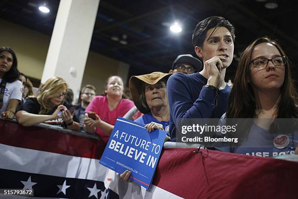 Attendees listen as Senator Bernie Sanders, an independent from Vermont and 2016 Democratic presidential candidate, not pictured, speaks during a...