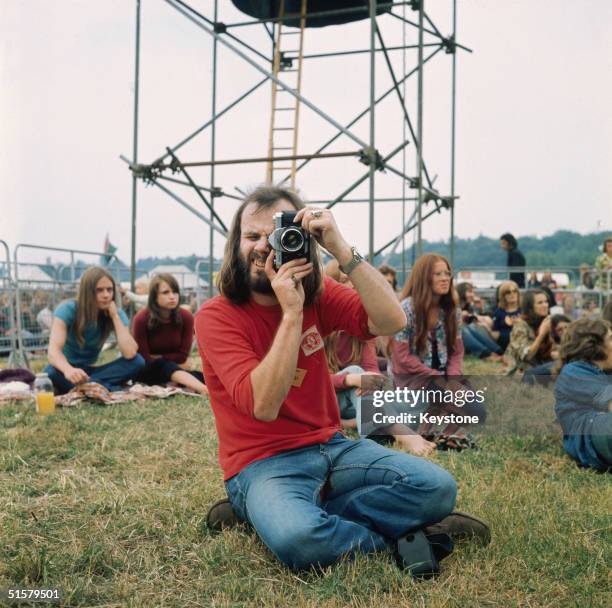 Radio 1 disc jockey and champion of new music John Peel , in a Liverpool F.C. Shirt, at the Reading Pop Festival in Berkshire, circa 1970.