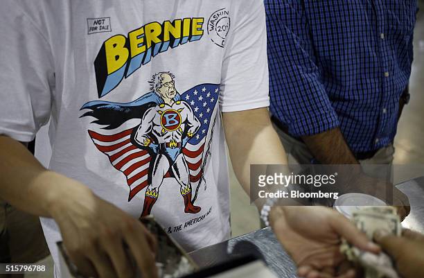 An attendee purchases concessions while waiting for the start of a campaign event for Senator Bernie Sanders, an independent from Vermont and 2016...