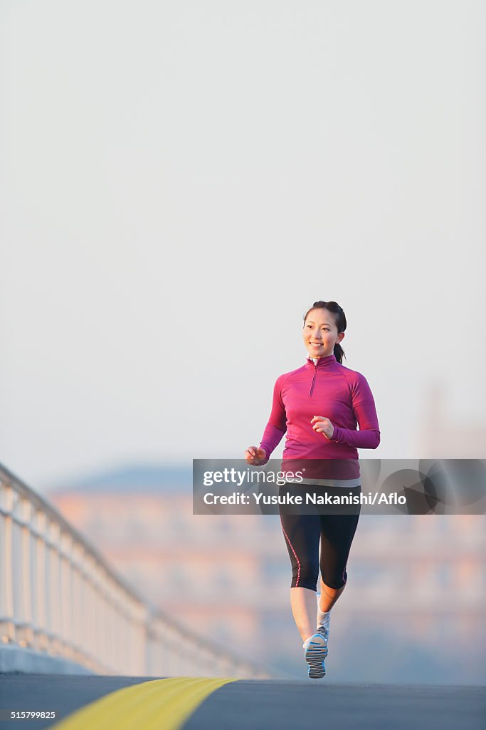 Young Japanese girl jogging