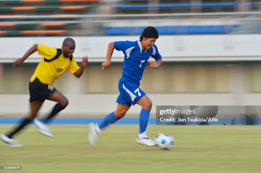 Football players running with ball