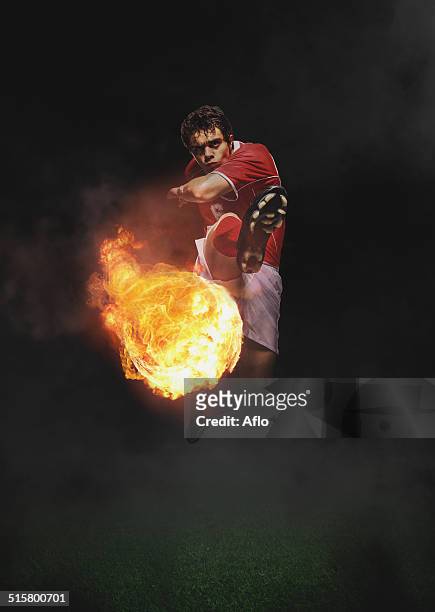 soccer player kicking the ball in mid-air - spiking stock pictures, royalty-free photos & images