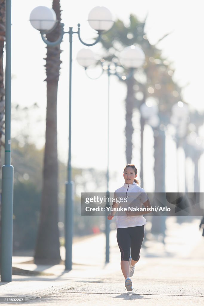 Young Japanese girl jogging