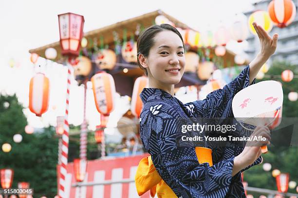 young japanese woman in a traditional kimono at a summer festival - hand fan stock pictures, royalty-free photos & images