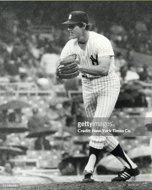 American professional baseball player pitcher Jim Kaat makes his New York Yankee debut in the rain during the seventh inning at Yankee Stadium...