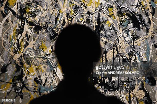 Woman looks at "Autumn Landscape" of famous US painter Jackson Pollock at the museum Palazzo Ruspoli in Rome, 27 October 2004. The exhibition called...